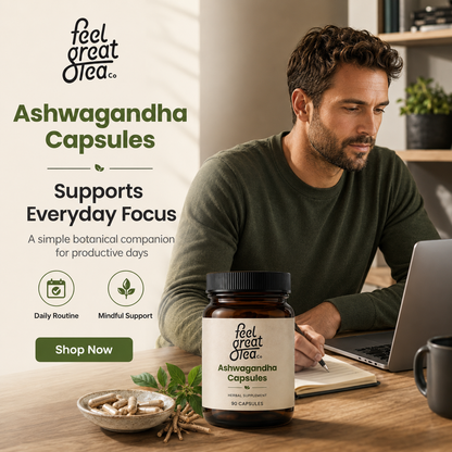 Man sitting at a desk with Ashwagandha capsules and a laptop, featuring 'feel great tea' branding.